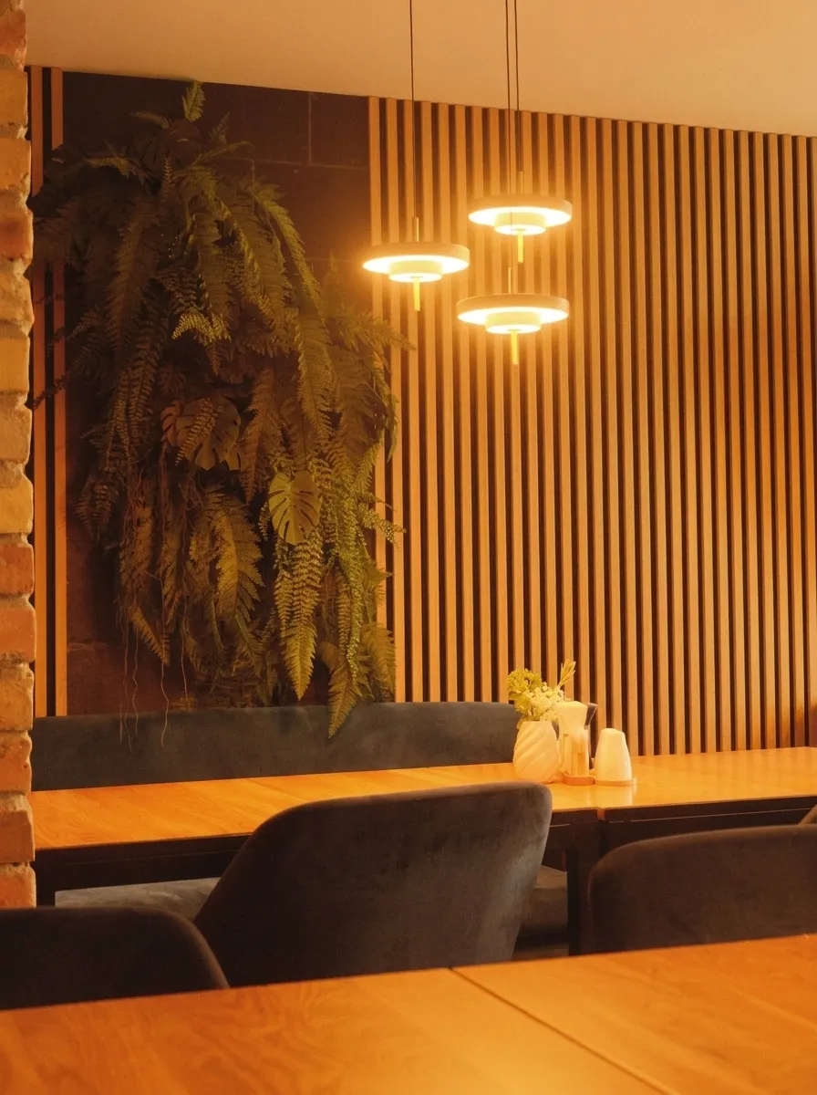 Pared revestida con paneles de listones de madera y iluminación LED trasera